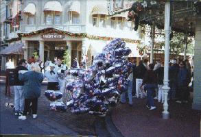 A cast member keeps balloons under control